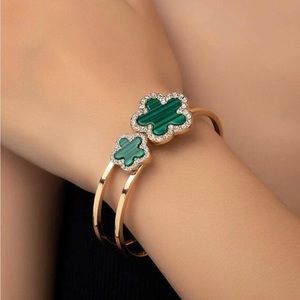 Gold tone green clove bangle.
